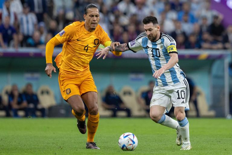 LUSAIL CITY, QATAR - DECEMBER 09:: Lionel Messi of Argentina and Virgil van Dijk of The Netherlands in action during the FIFA World Cup Qatar 2022 quarter final match between Netherlands (2) and Argentina (2) (Argentina win 4-3 on penalties) at Lusail Stadium on December 09, 2022 in Lusail City, Qatar. (Photo by Simon Bruty/Anychance/Getty Images)
